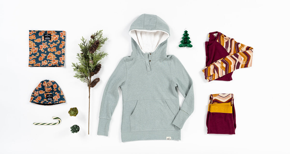 A collection of clothing and accessories for the Boss Babe Gift Guide, including a hoodie, leggings, and decorative items.