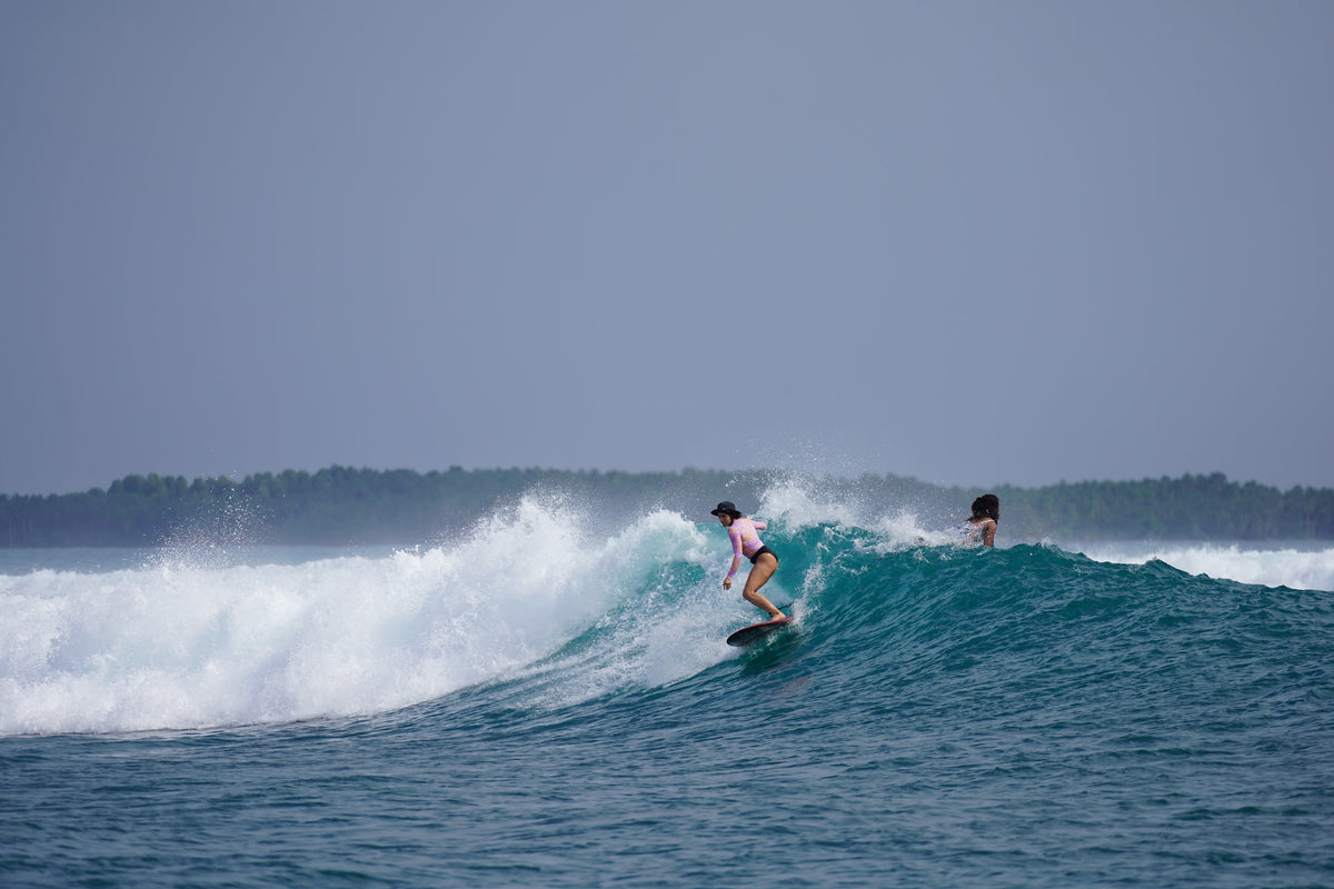 Kelsey Van Patten surfing on a wave
