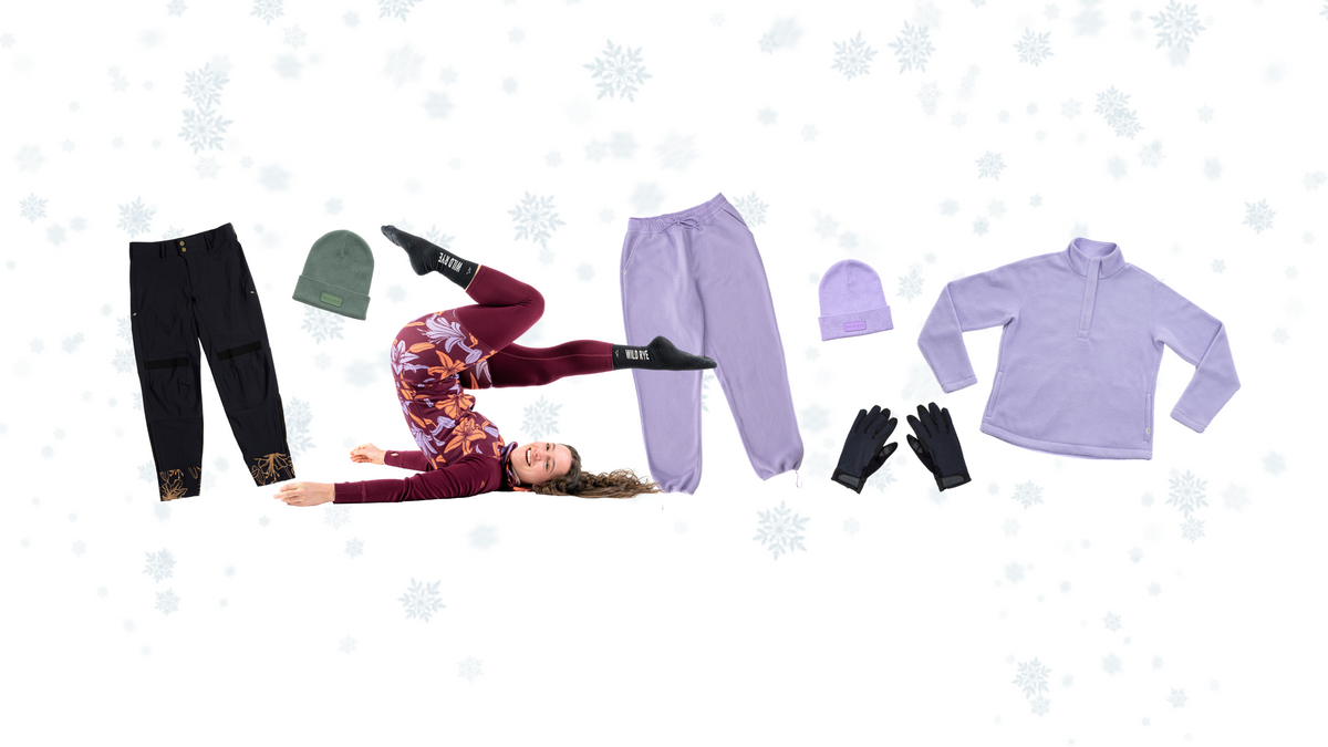 A collection of winter clothing items including pants, a top, gloves, and hats, displayed with a person in a playful pose.