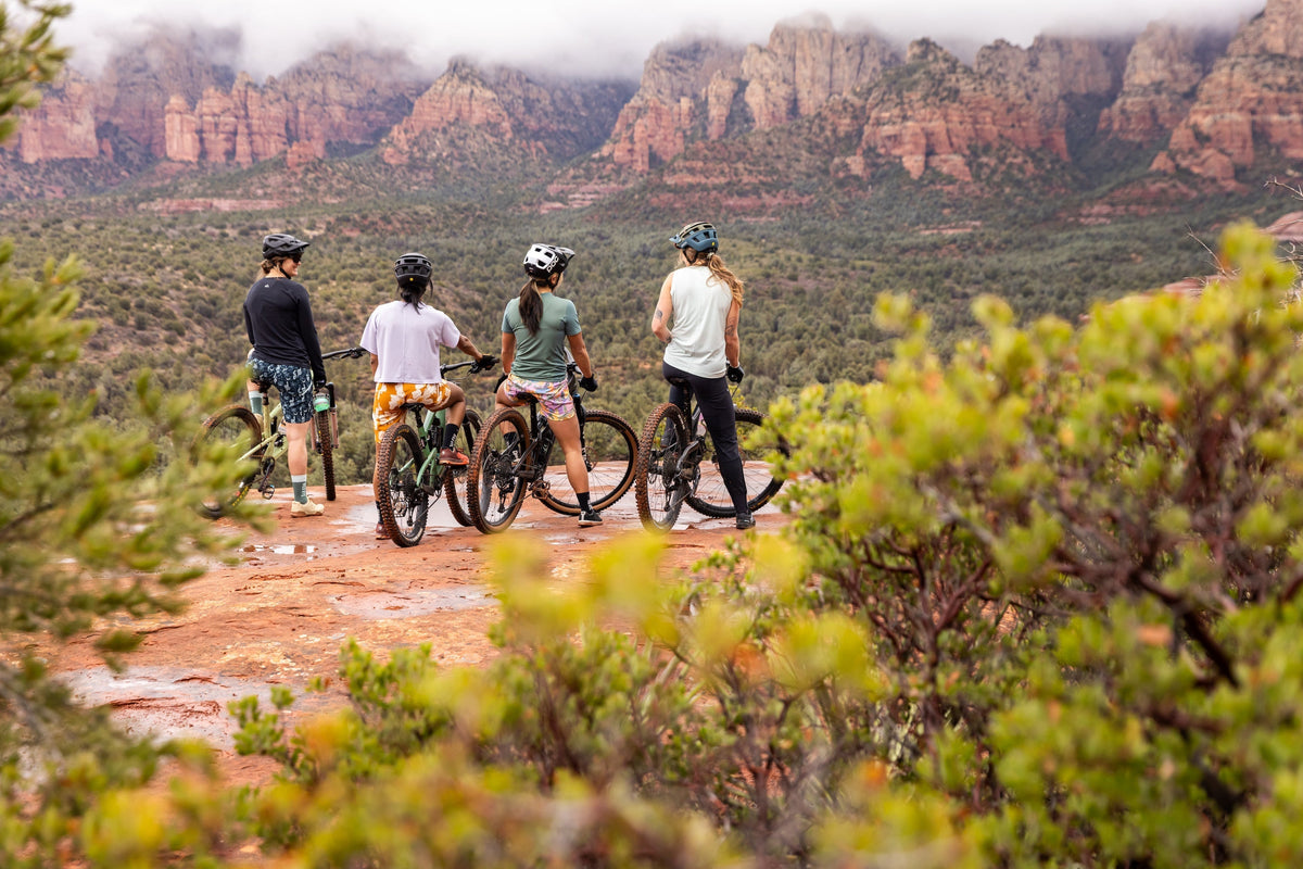 Group of mountain bikers overlooking redrock vistas in Sedona, AZ