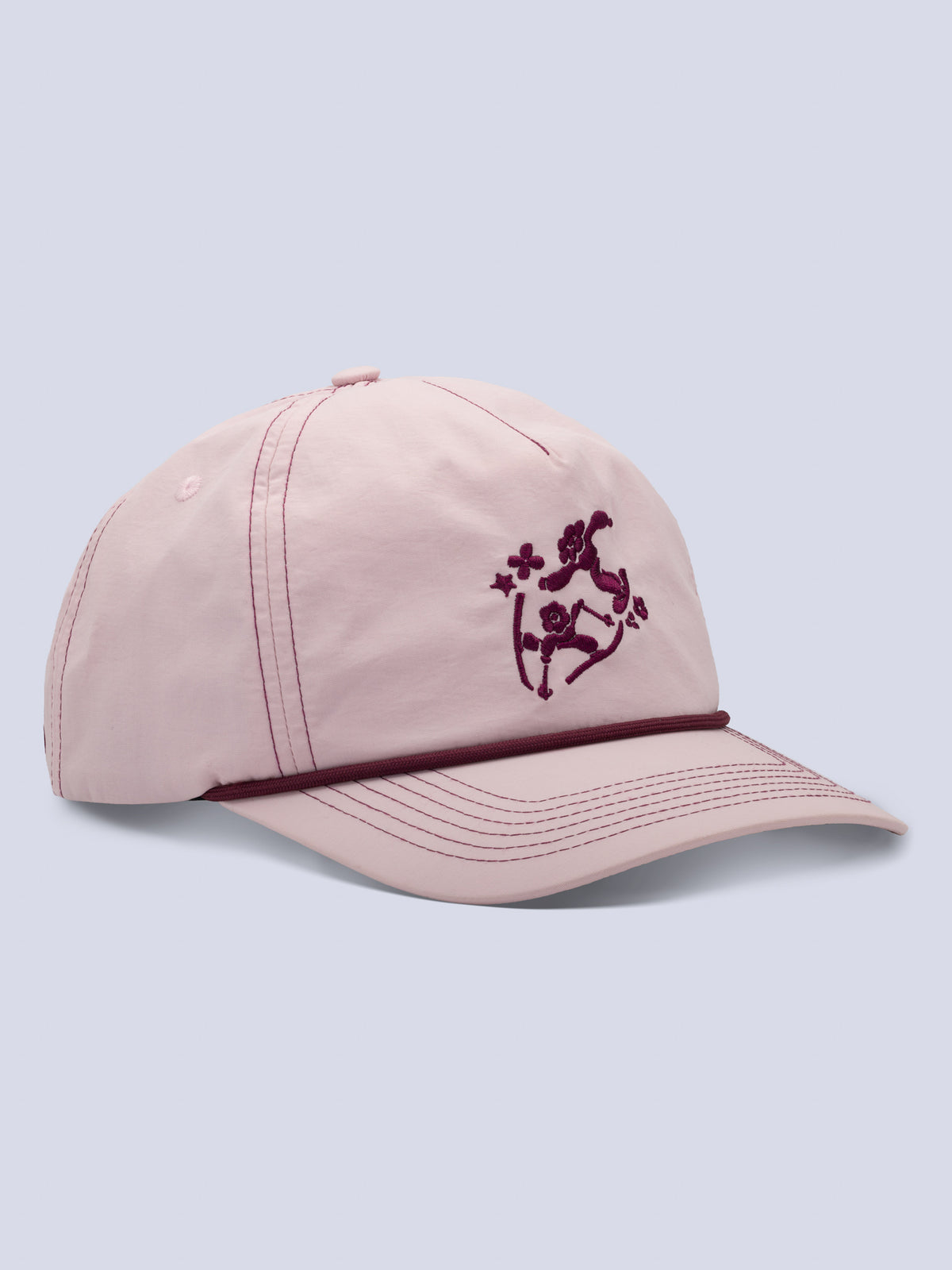 Pink trucker hat with embroidered maroon skier design and rope detail at brim