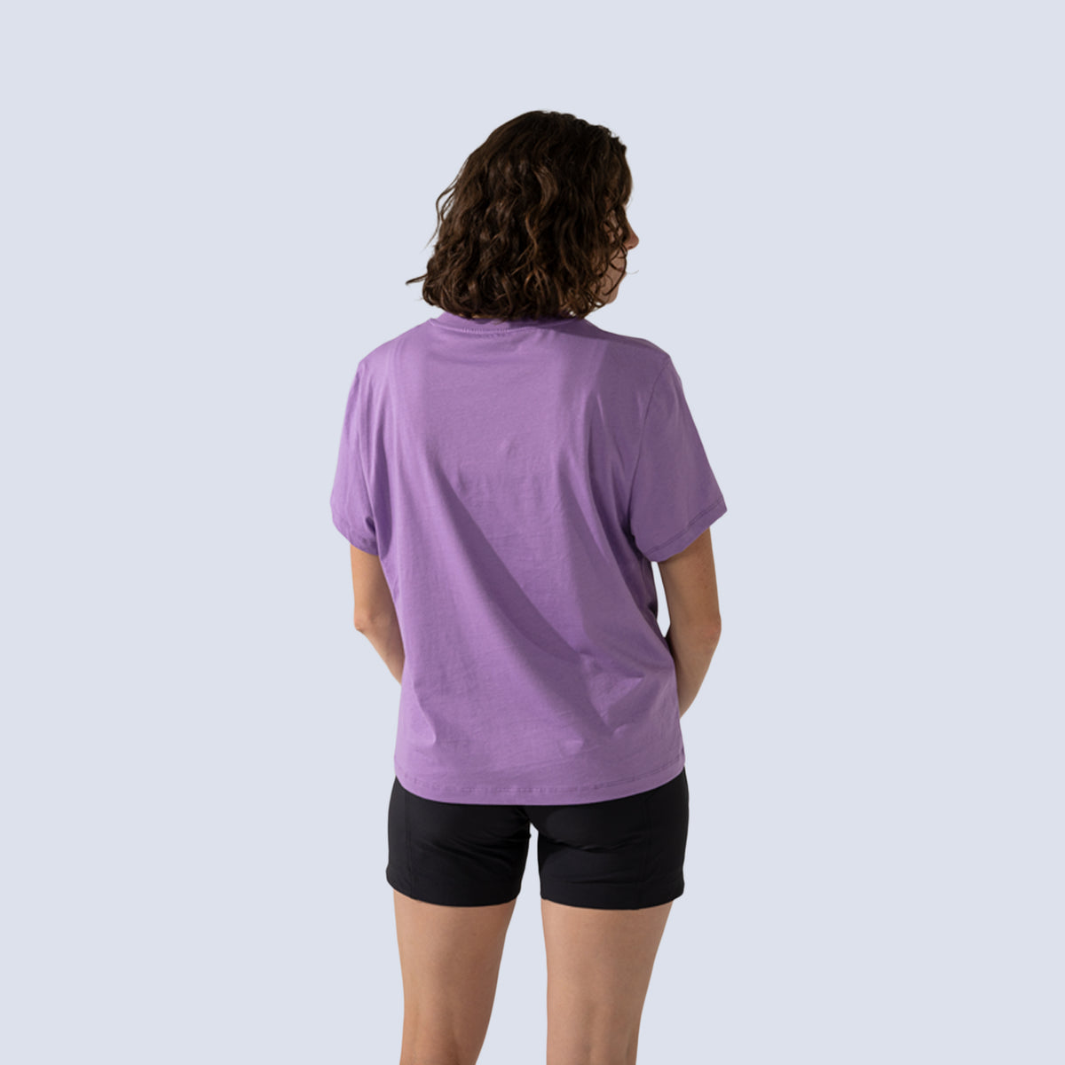 Woman wearing purple t-shirt back view