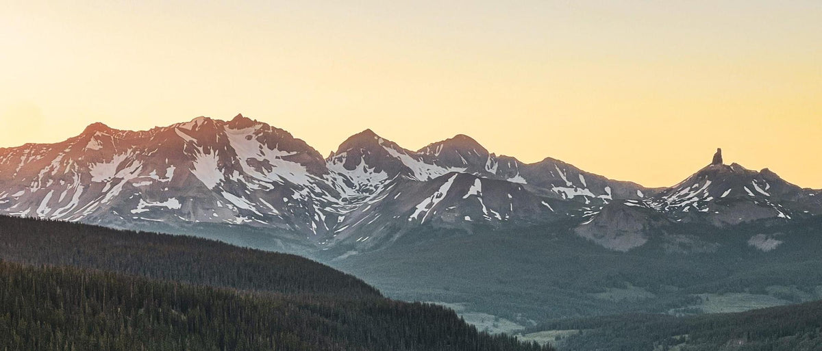 Mountain range at sunset with snow-capped peaks
