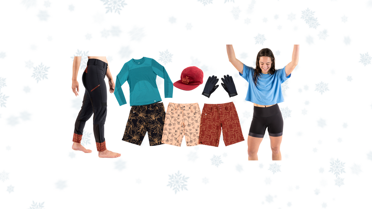 A collection of biking apparel including shorts, gloves, and tops for women.