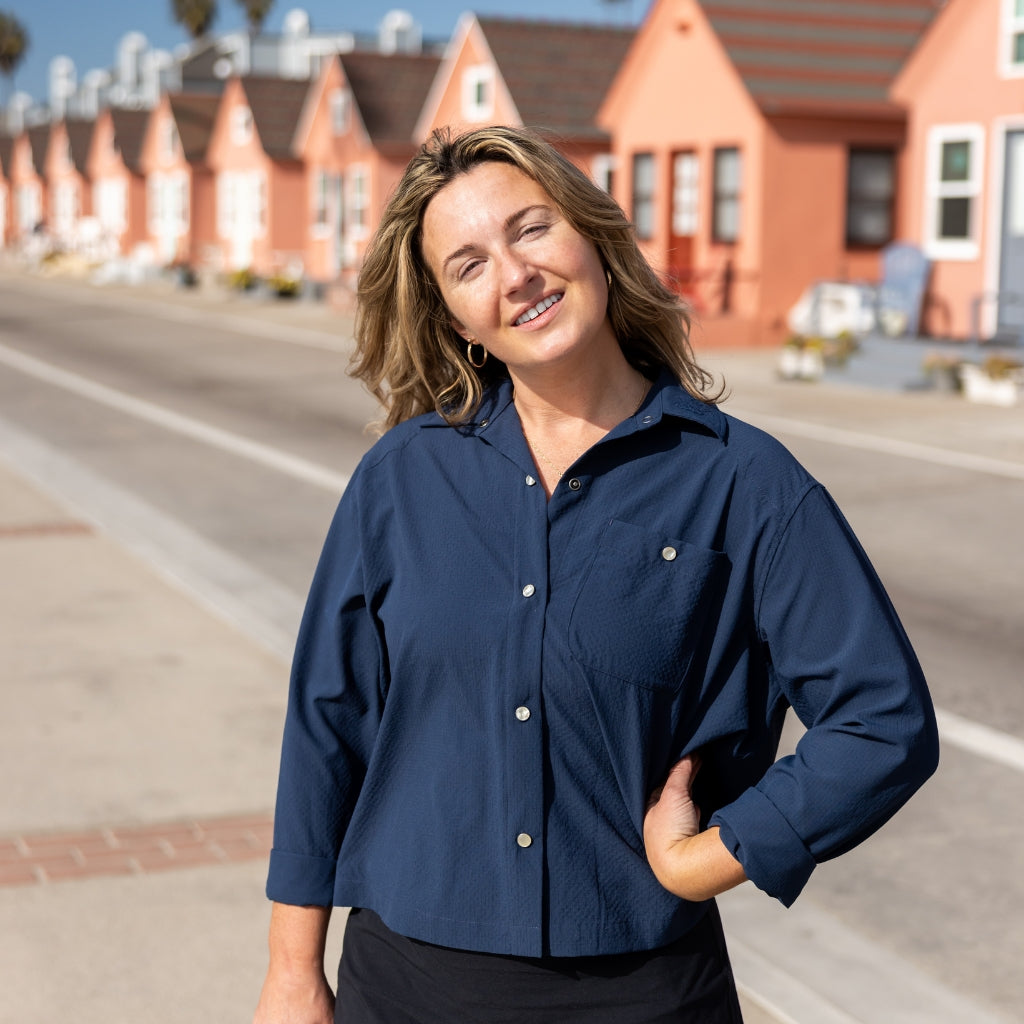 [Midnight] Woman standing in front of beachside cottages