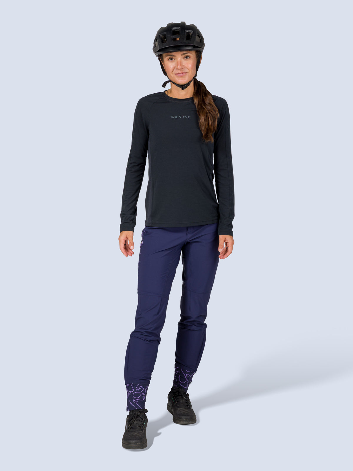 [Abyss Reef] Model wearing the Freyah Bike Pant in navy with a black long-sleeve top and helmet, full front view