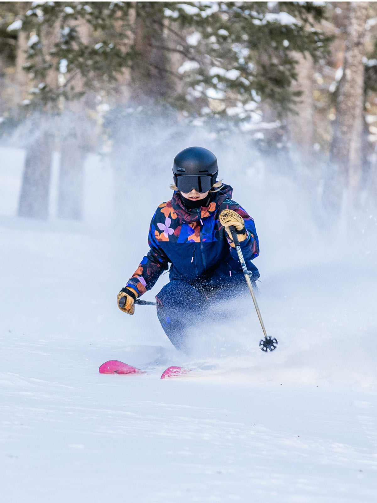 [Nightflora] Woman skiing through fresh powder in a snowy forest wearing a nightflora floral print Roundhouse 2L Insulated Jacket