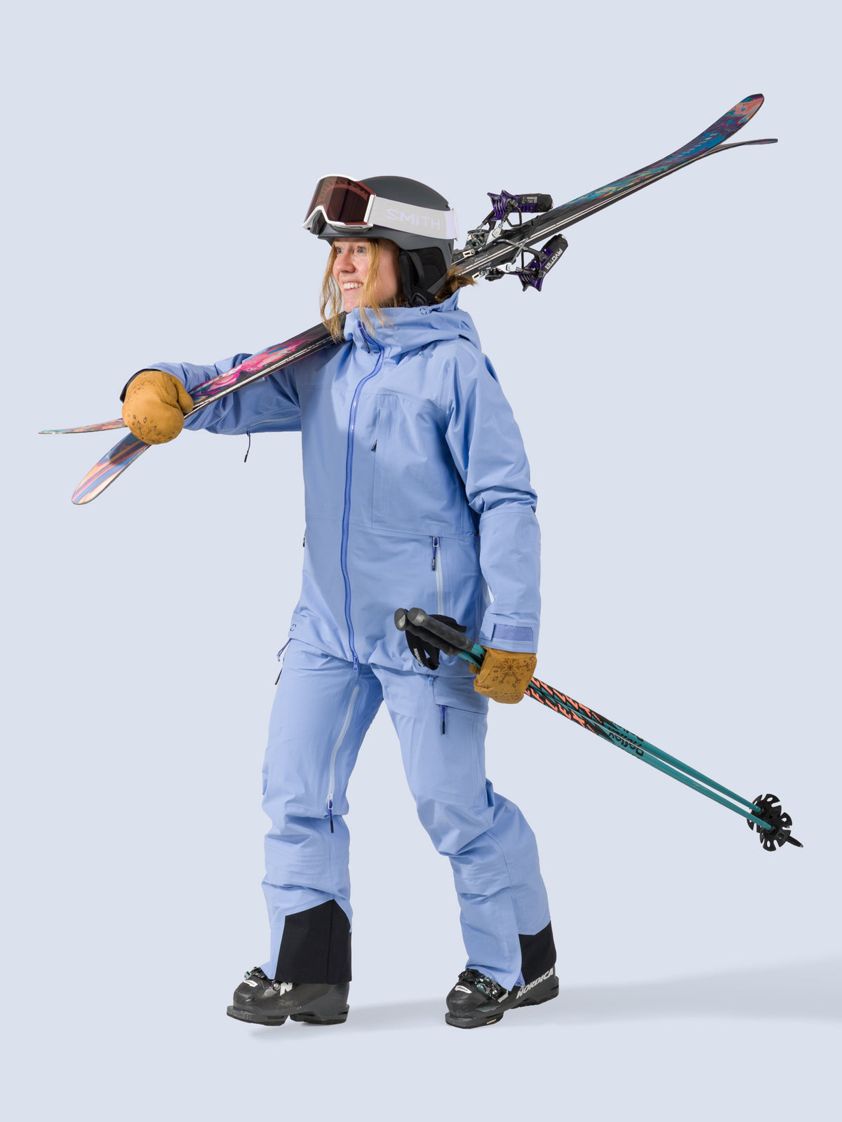 [Breeze] Butterfield 3L Pant in breeze light blue, on model carrying skis shot