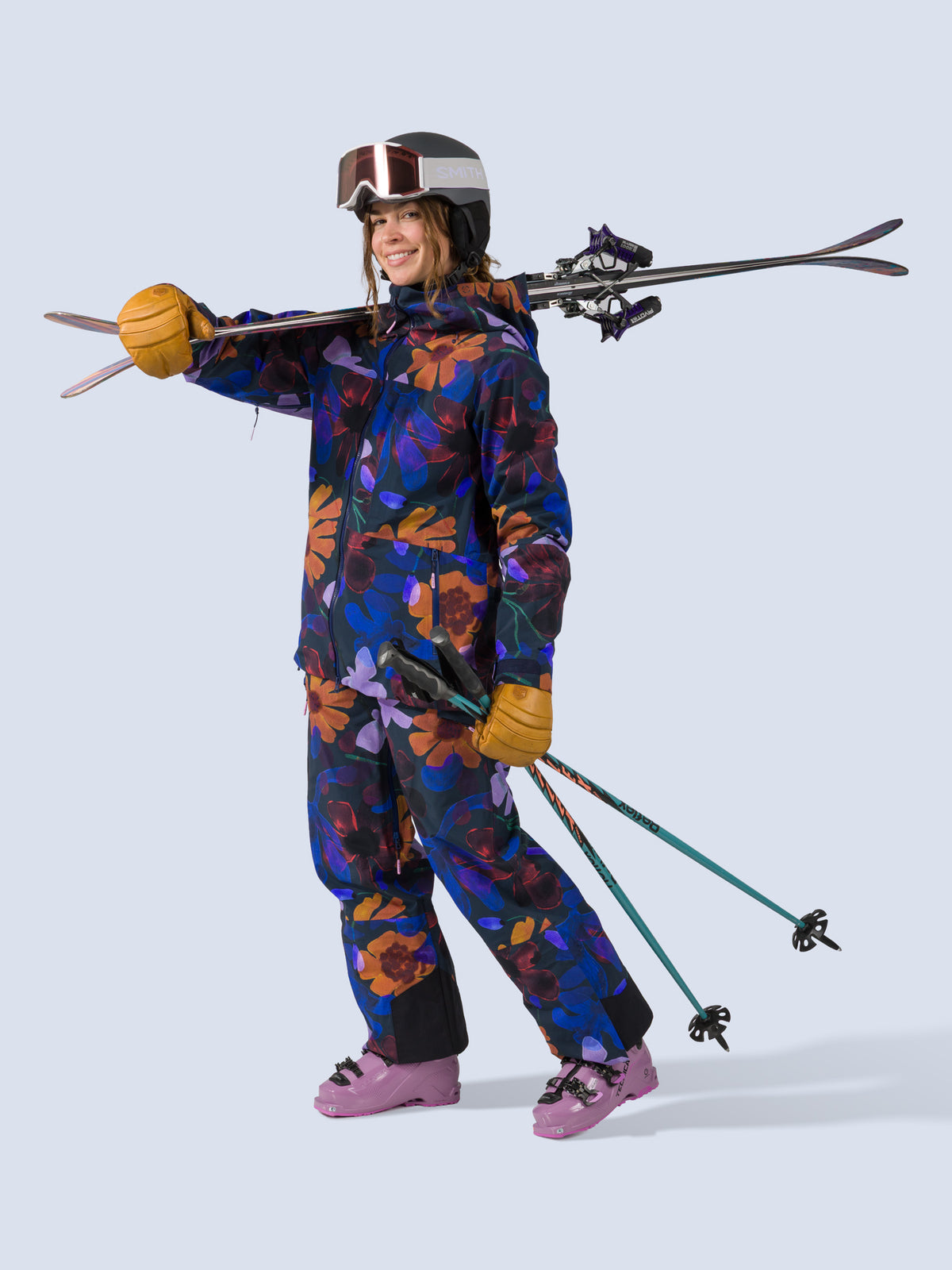 [Nightflora] Butterfield 3L Pant in nightflora floral print, on model carrying skis shot