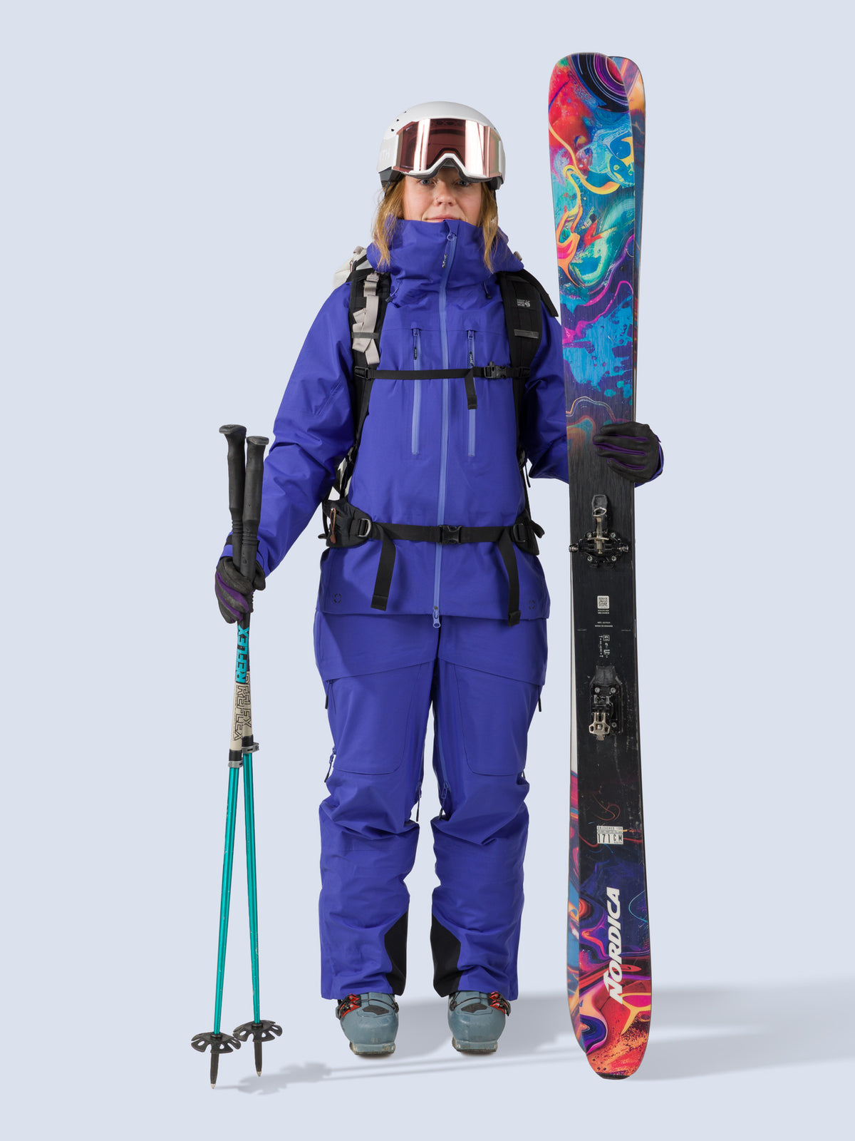 [Lapis] Heyburn 3L Jacket in lapis blue, on model with skis and poles shot