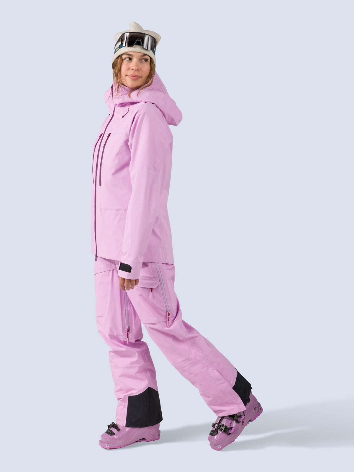 [Orchid] Heyburn 3L Bib in orchid pink, styled with the Heyburn 3L Jacket, on model walking shot