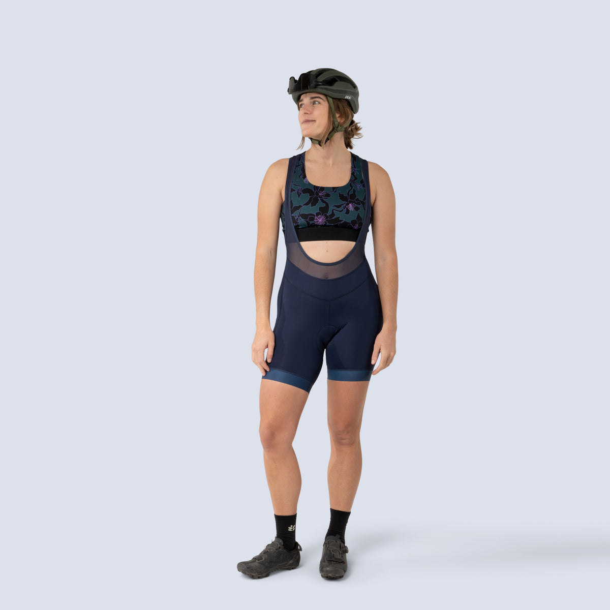 [Spruce Aquila Bloom] Lucille sports bra in green with black floral pattern, on model front full body view