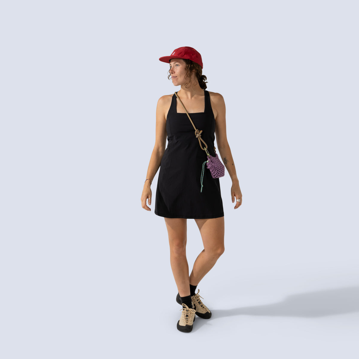 [Black] Woman wearing black Parker dress, and red cap 