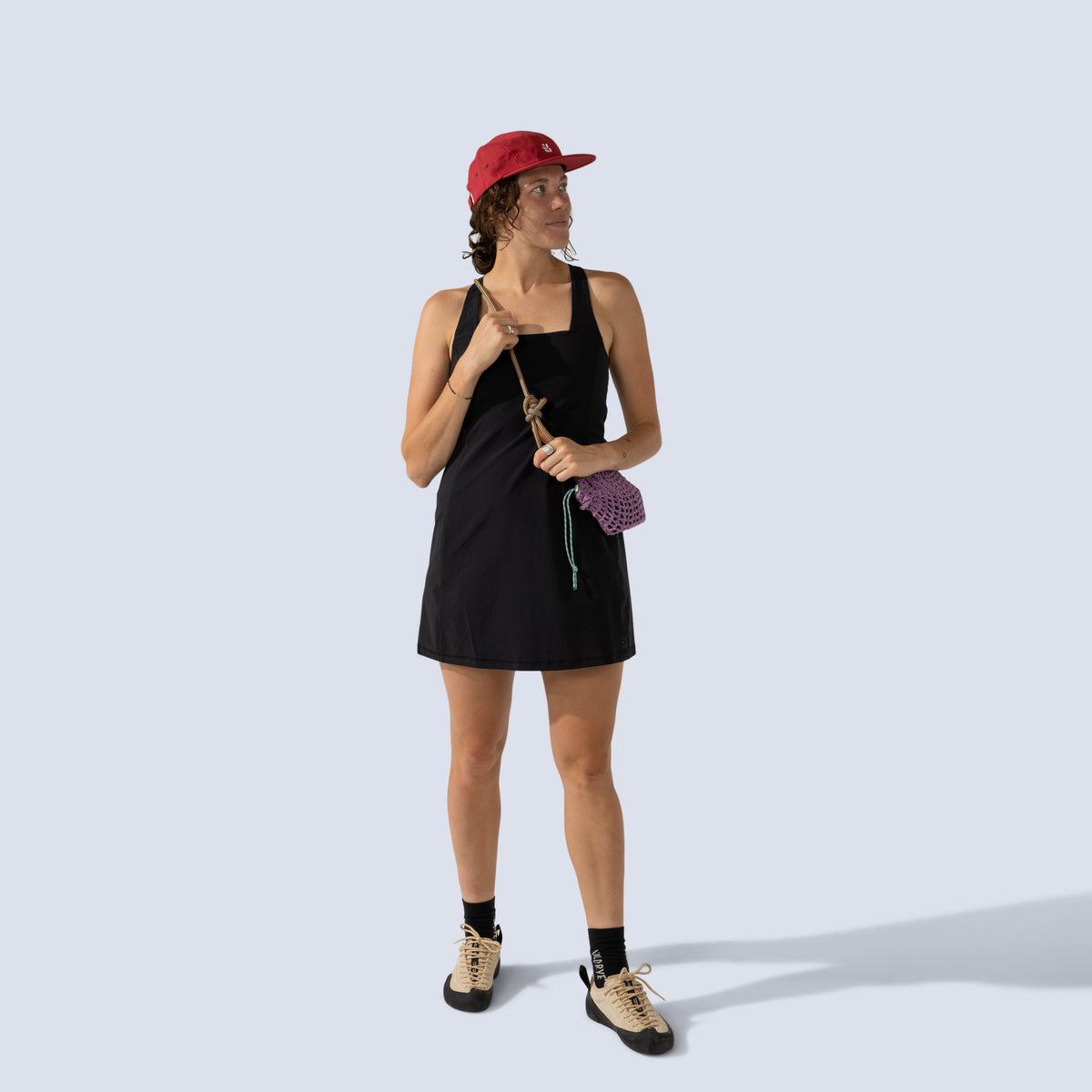 [Black] Woman wearing black Parker dress, and red cap 