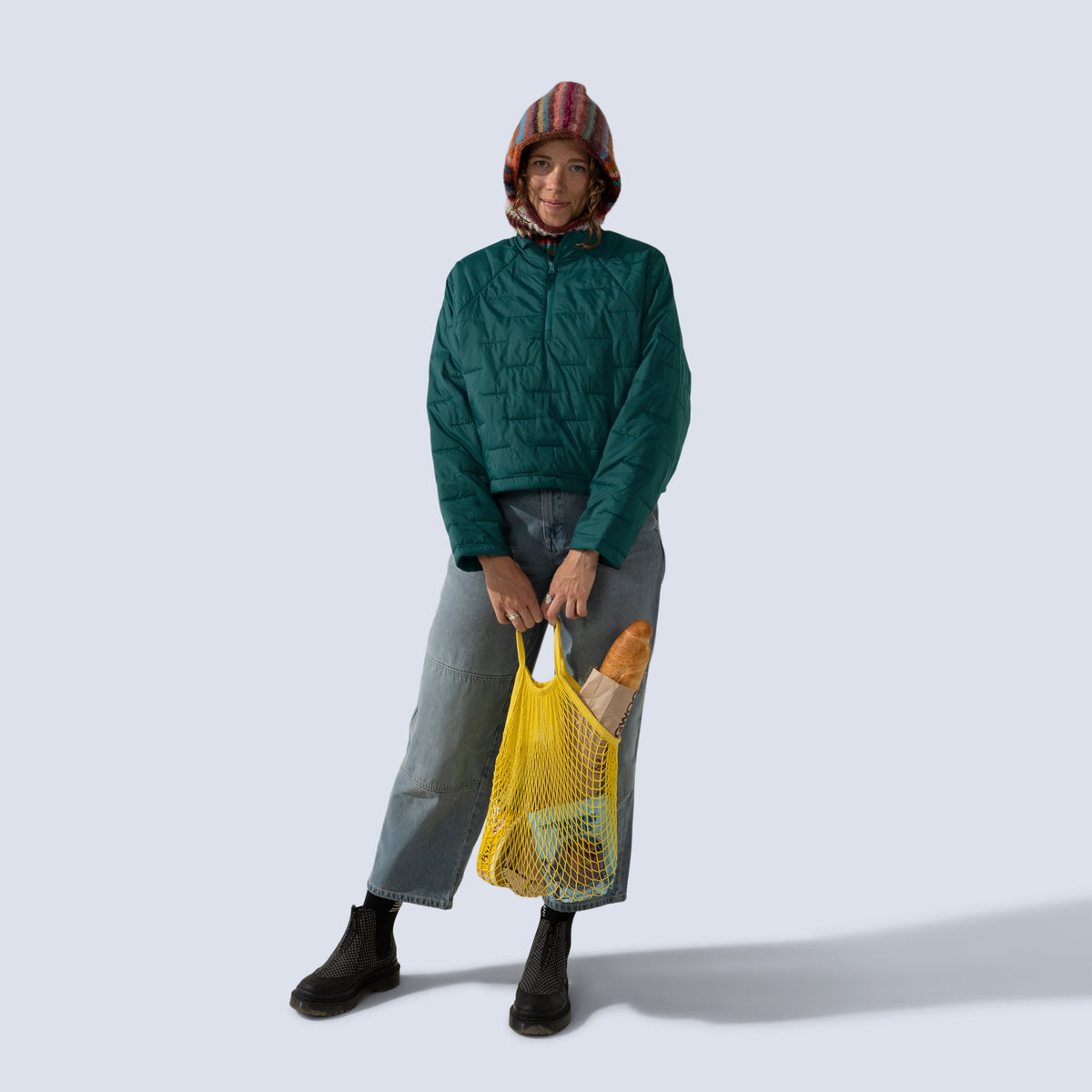 [Shaded Spruce] Payette insulated pullover in shaded spruce, model holding bag of groceries