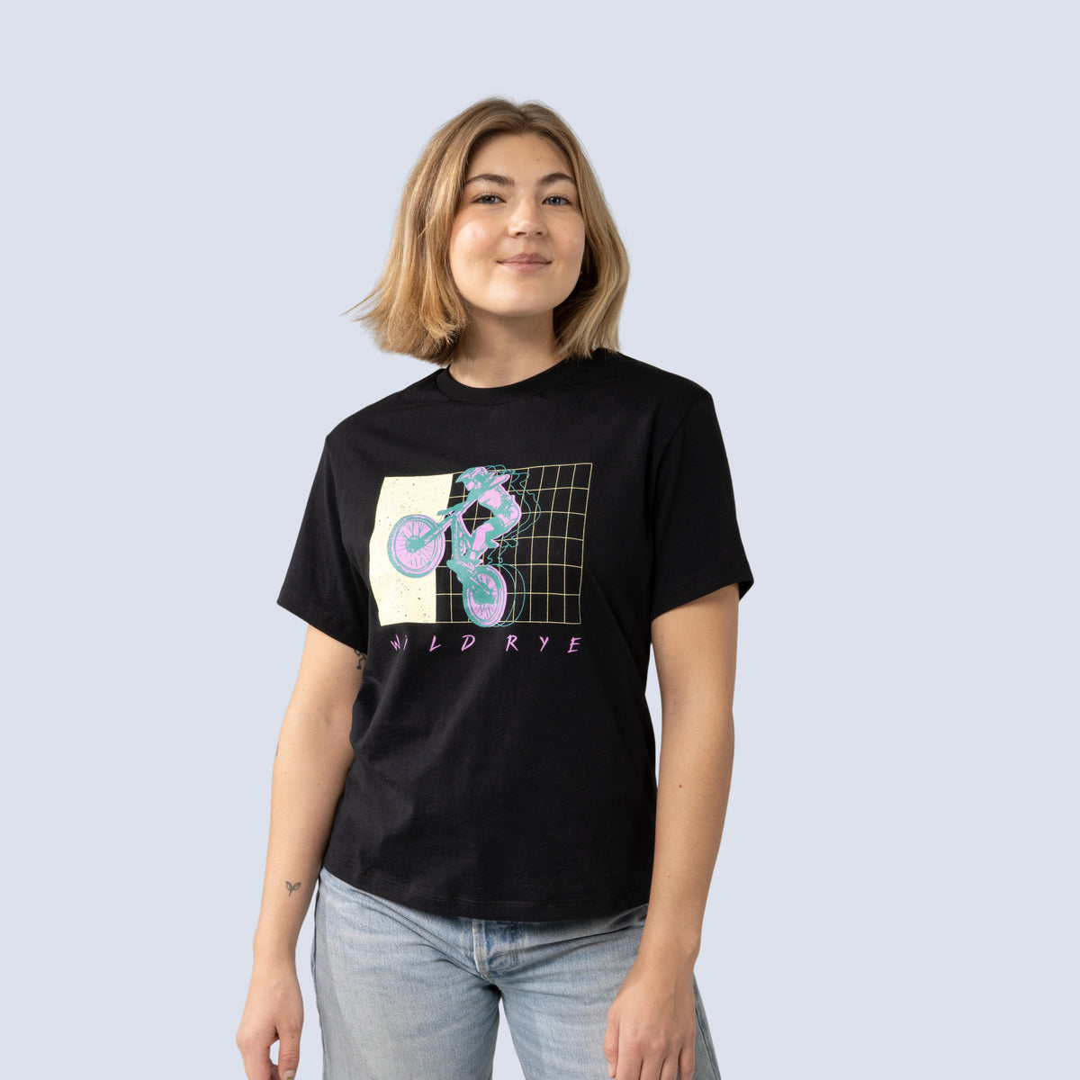 Person wearing a black t-shirt with a graphic design on a plain background